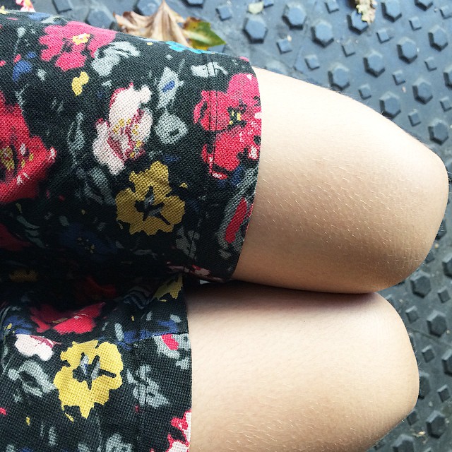 Piernas de Roser Amills con minifalda de flores sobre un suelo de baldosas