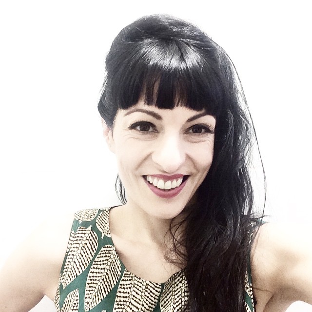 Roser Amills sonríe con flequillo y vestido estampado, maquillada por Vanessa Peña