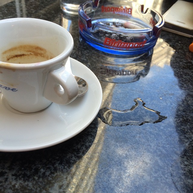 Taza de café en una mesa de mármol de un bar romano
