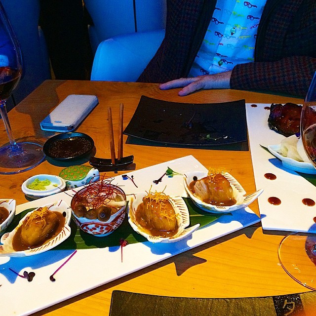 Bandeja de erizos y tapas japonesas en una cena con vino tinto