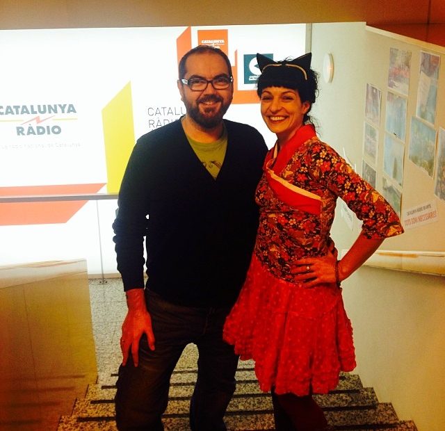 Roser Amills, con orejas de gato y vestido rojo, posa con Quim Bonet en la escalera de Catalunya Ràdio