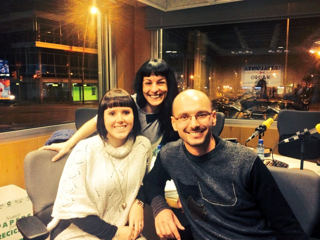 Roser Amills, Helena Àngel i Dani Borrell somriuen a l'estudi de Catalunya Ràdio, de nit