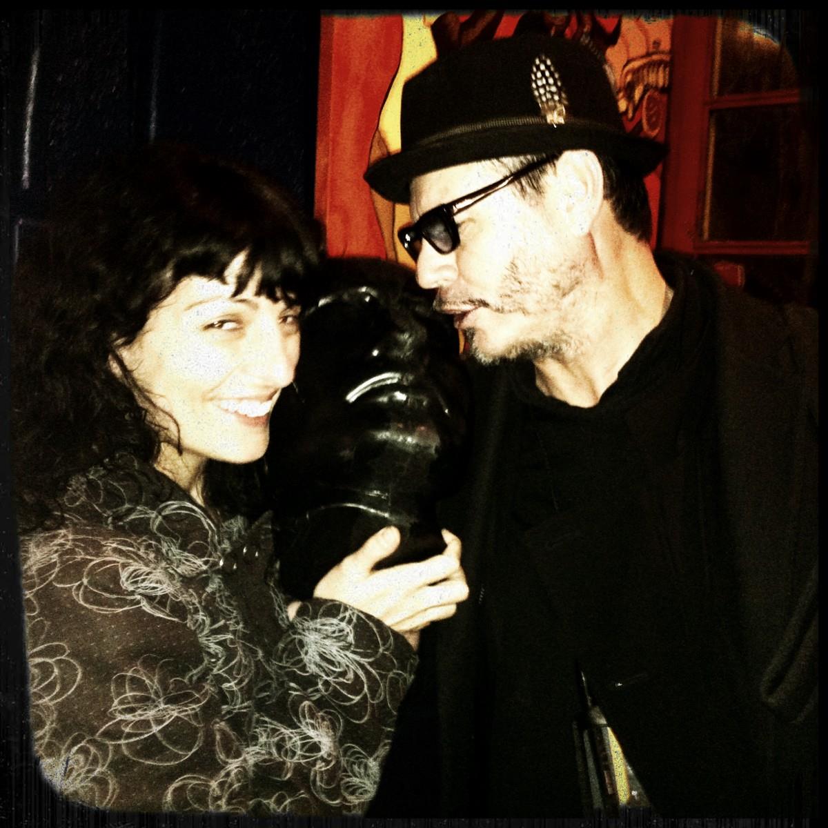 Roser Amills y Chu Uroz, con sombrero y gafas, posan junto a una escultura negra