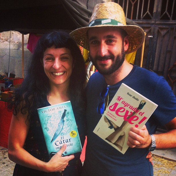 Roser Amills y un lector con los libros El Càtar imperfecte y M'agrada el sexe! en la feria medieval de Sant Mateu