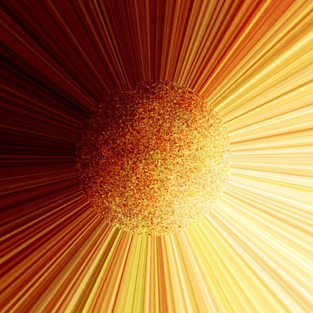 Efecto óptico en una foto del móvil: esfera naranja y dorada rodeada de rayos de luz