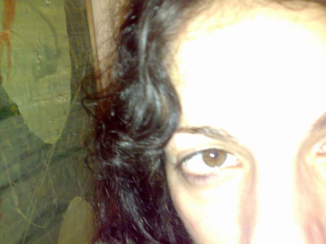 Primer plano de un ojo y del pelo rizado de Roser Amills